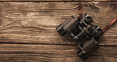 a pair of binoculars on a wooden table