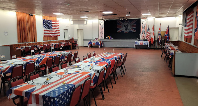the concert hall at Bilston Sports and Social Club with tables laid out with patriotic table cloths